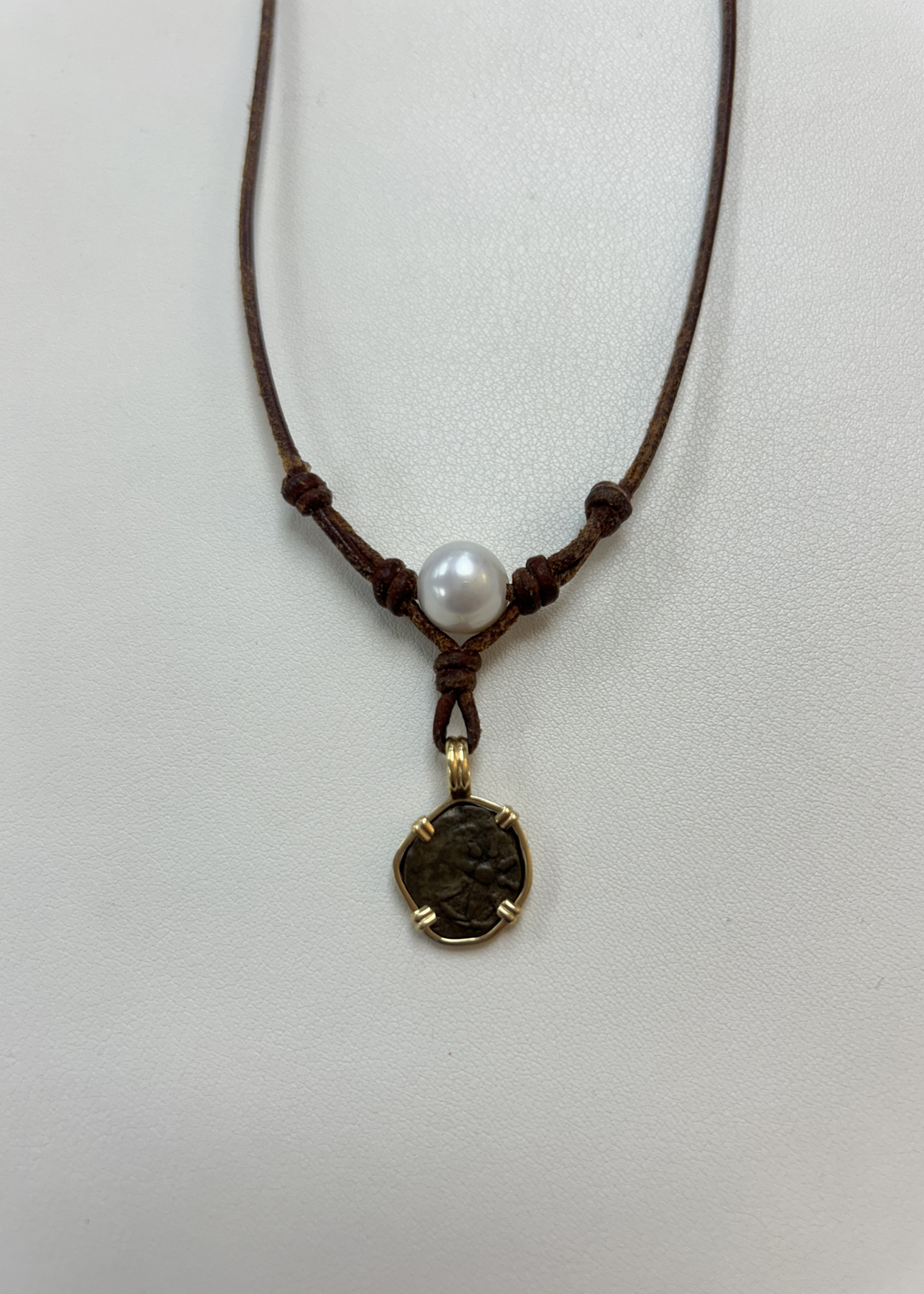 Brown leather necklace with a pearl and vintage coin
