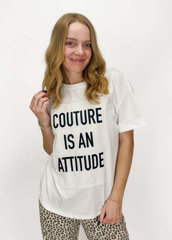 woman wearing short sleeve white tee with "couture is an attitude" chest graphic
