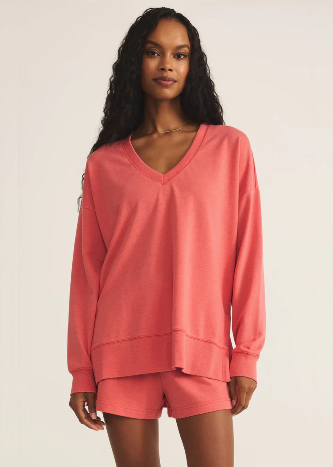 Woman wearing Z Supply coral v-neck sweatshirt 