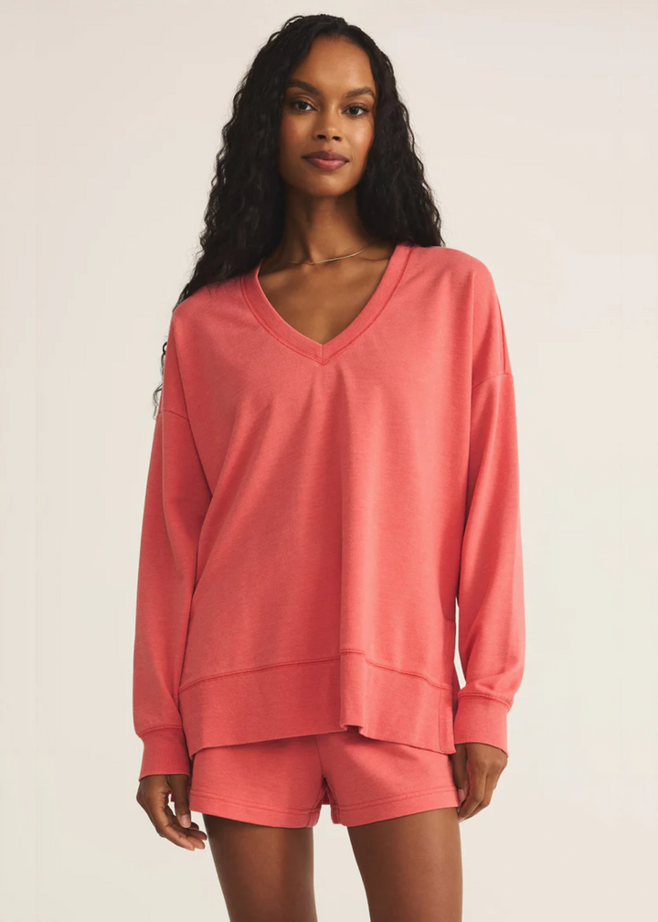 Woman wearing Z Supply coral v-neck sweatshirt 
