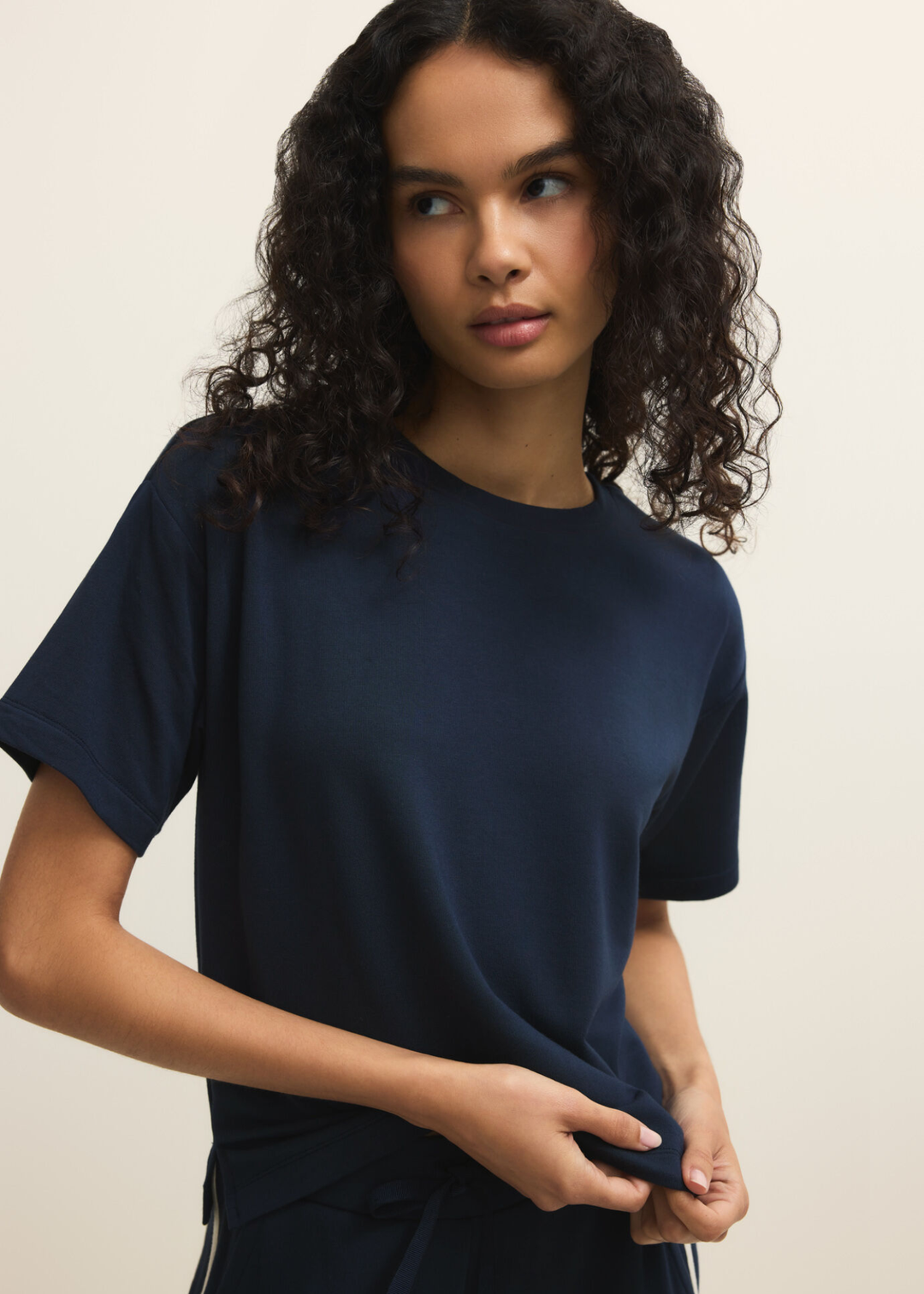 Woman wearing a navy short sleeve tee with navy pants
