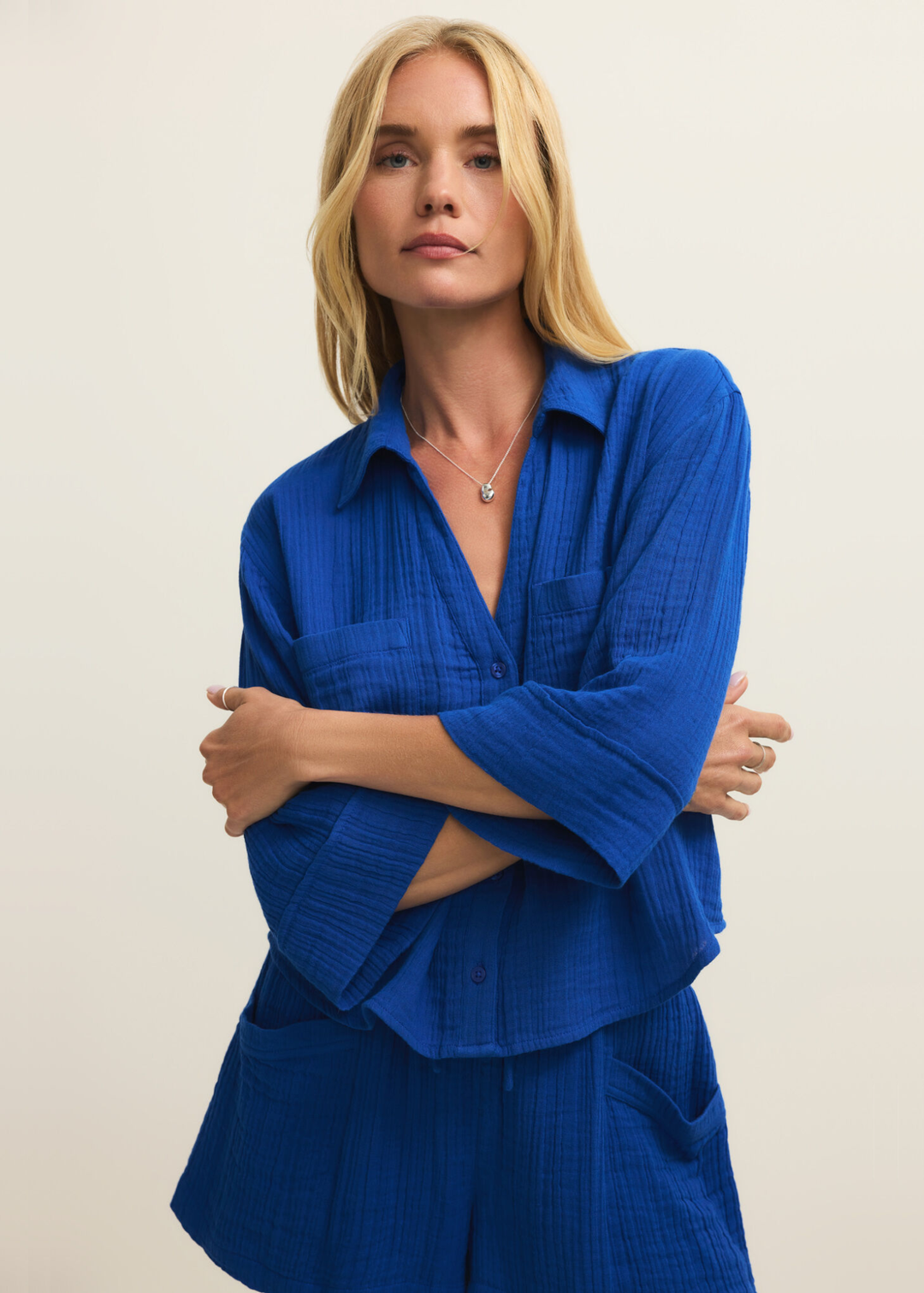 Woman wearing a blue button down with matching shorts
