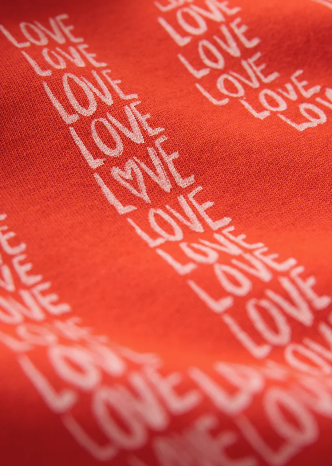 Close up of a red sweatshirt with a "USA" graphic and love lettering