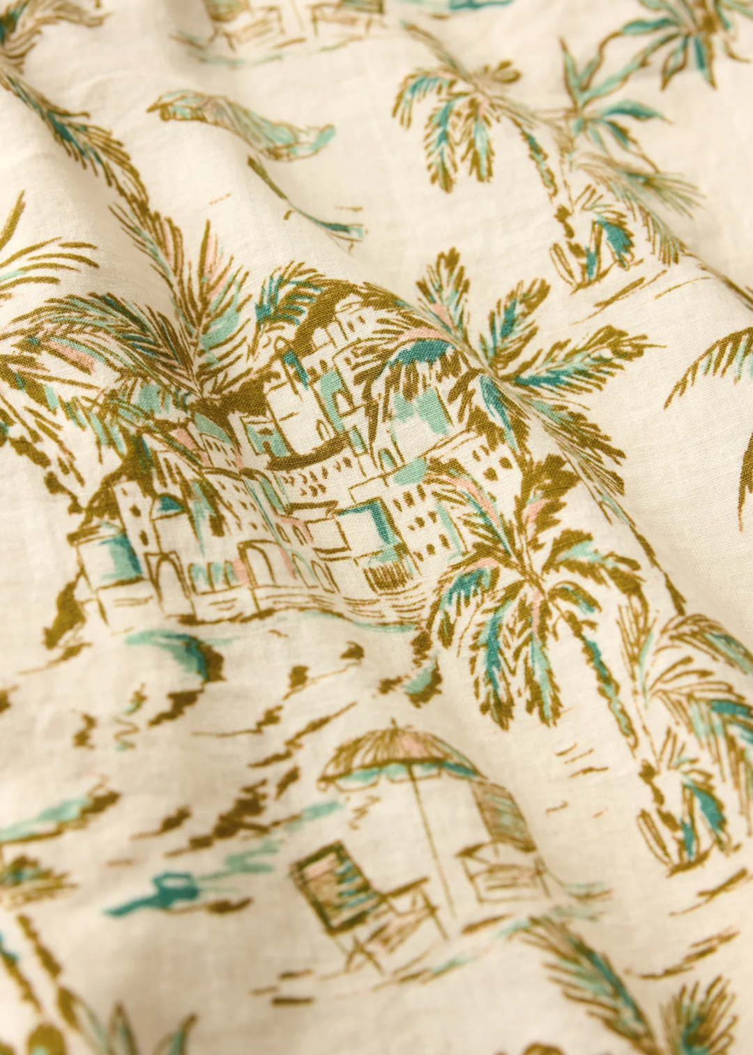 Close up of a cream fabric with a tropical print