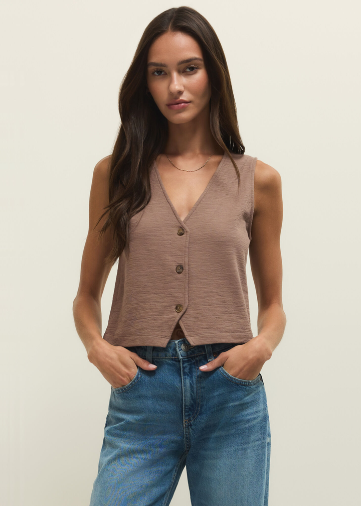 Woman wearing a brown textured button down tank with jeans