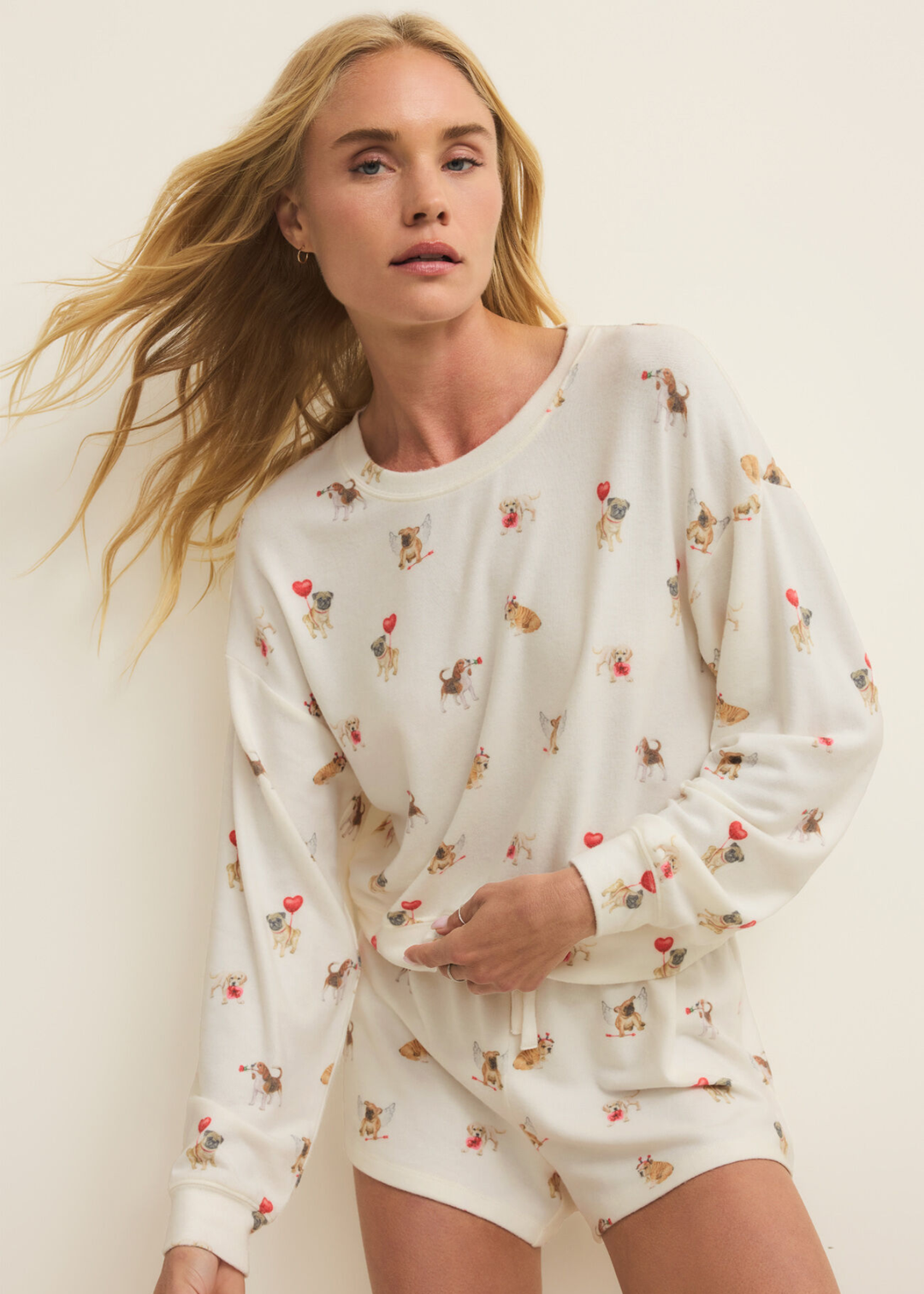 Woman wearing white pajamas with a graphic dog pattern