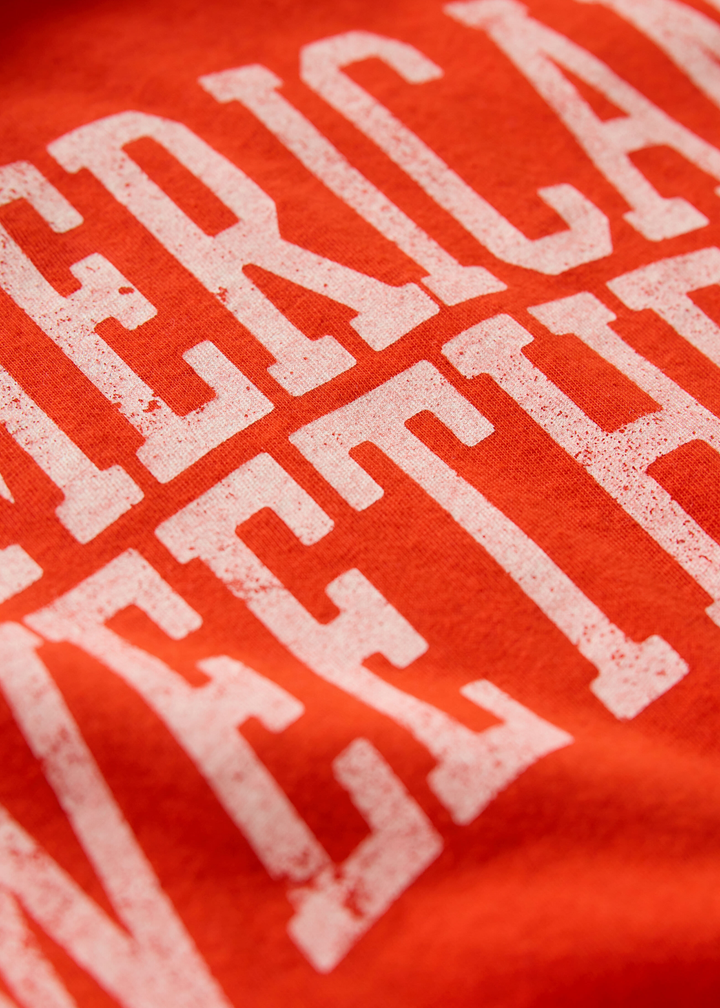Close up of a red t-shirt with an "American Sweetheart" graphic