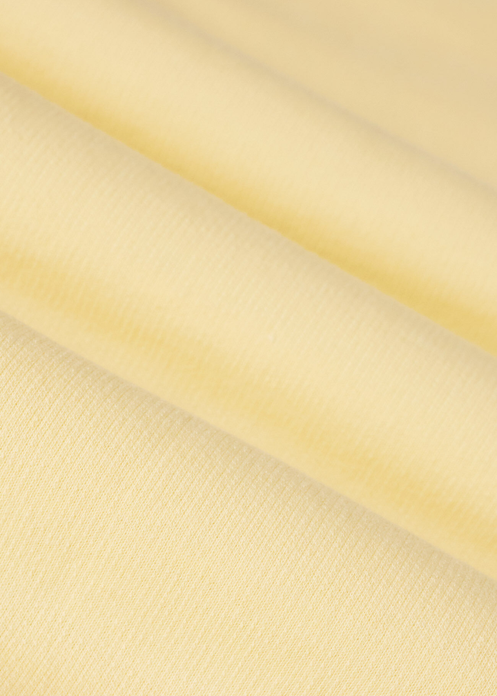 Close up of yellow knit fabric