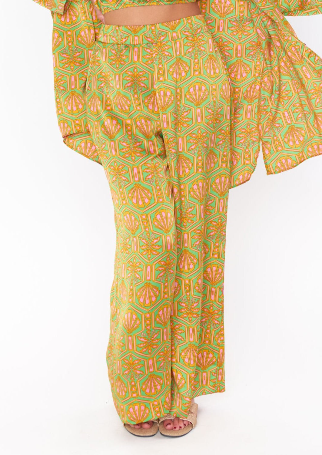 green satin pants with orange and pink art deco palm tree print