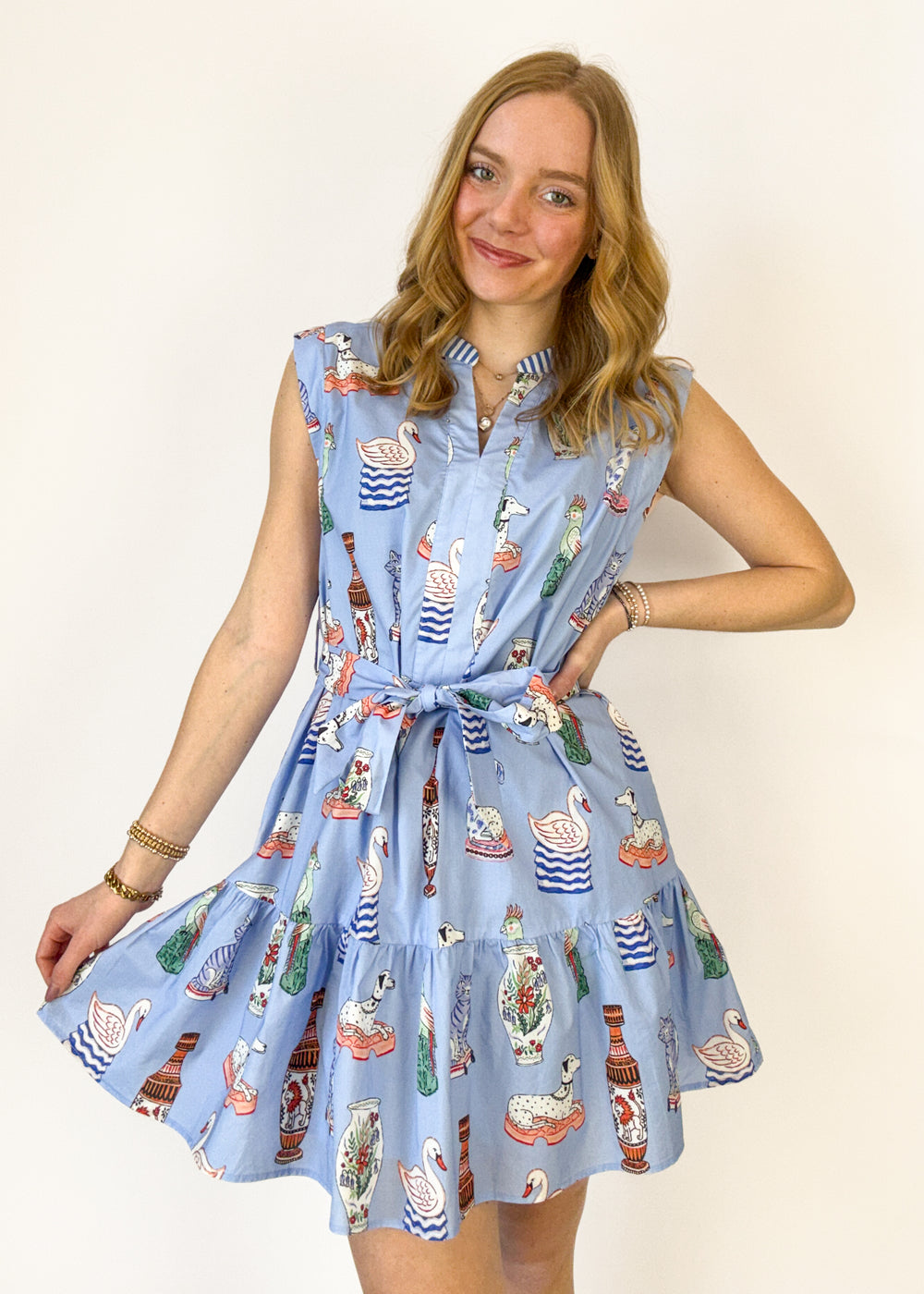 Woman wearing a blue patterned dress against a white background