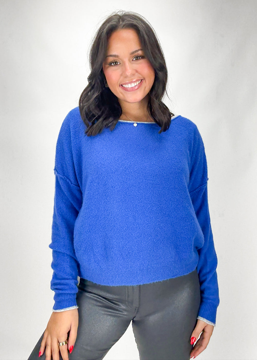 Woman wearing a blue sweater against a white background