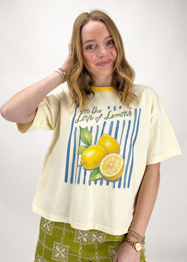 Woman wearing a lemon-themed t-shirt with text on a white background