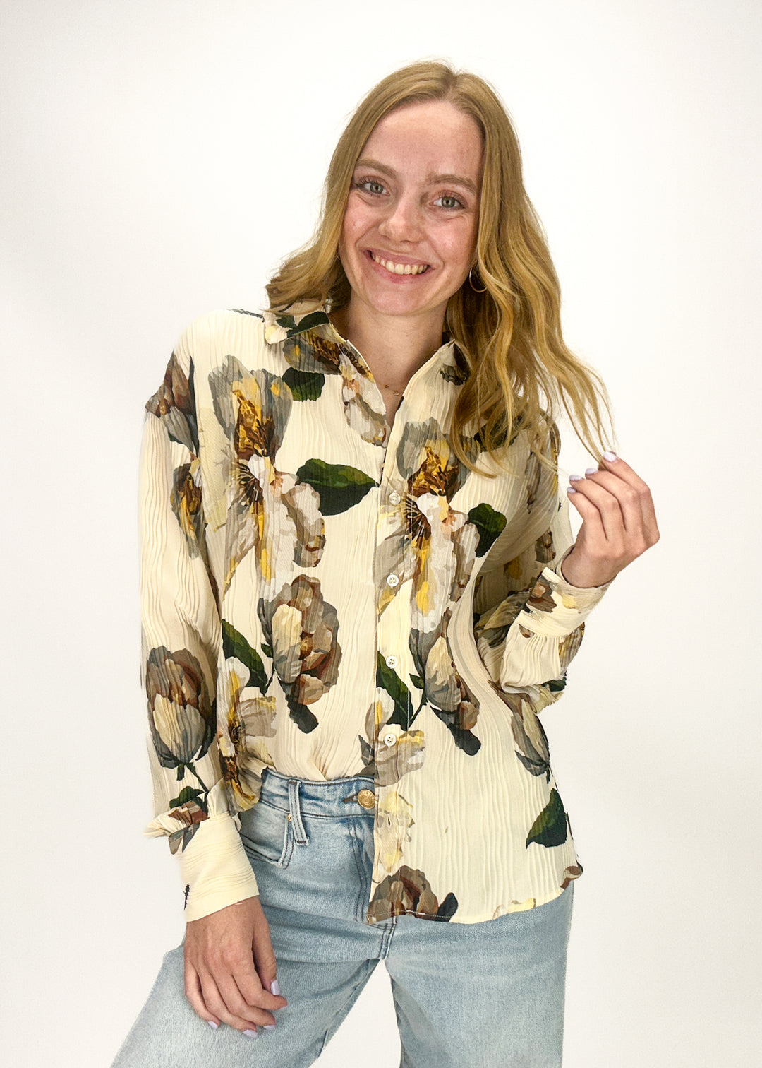 woman wearing beige, green, brown, and gold floral print collared button down top
