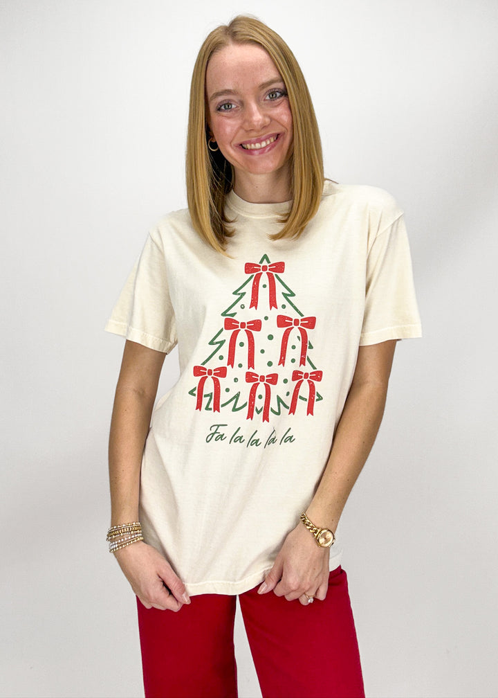 Woman wearing a cream t-shirt with a Christmas tree design 