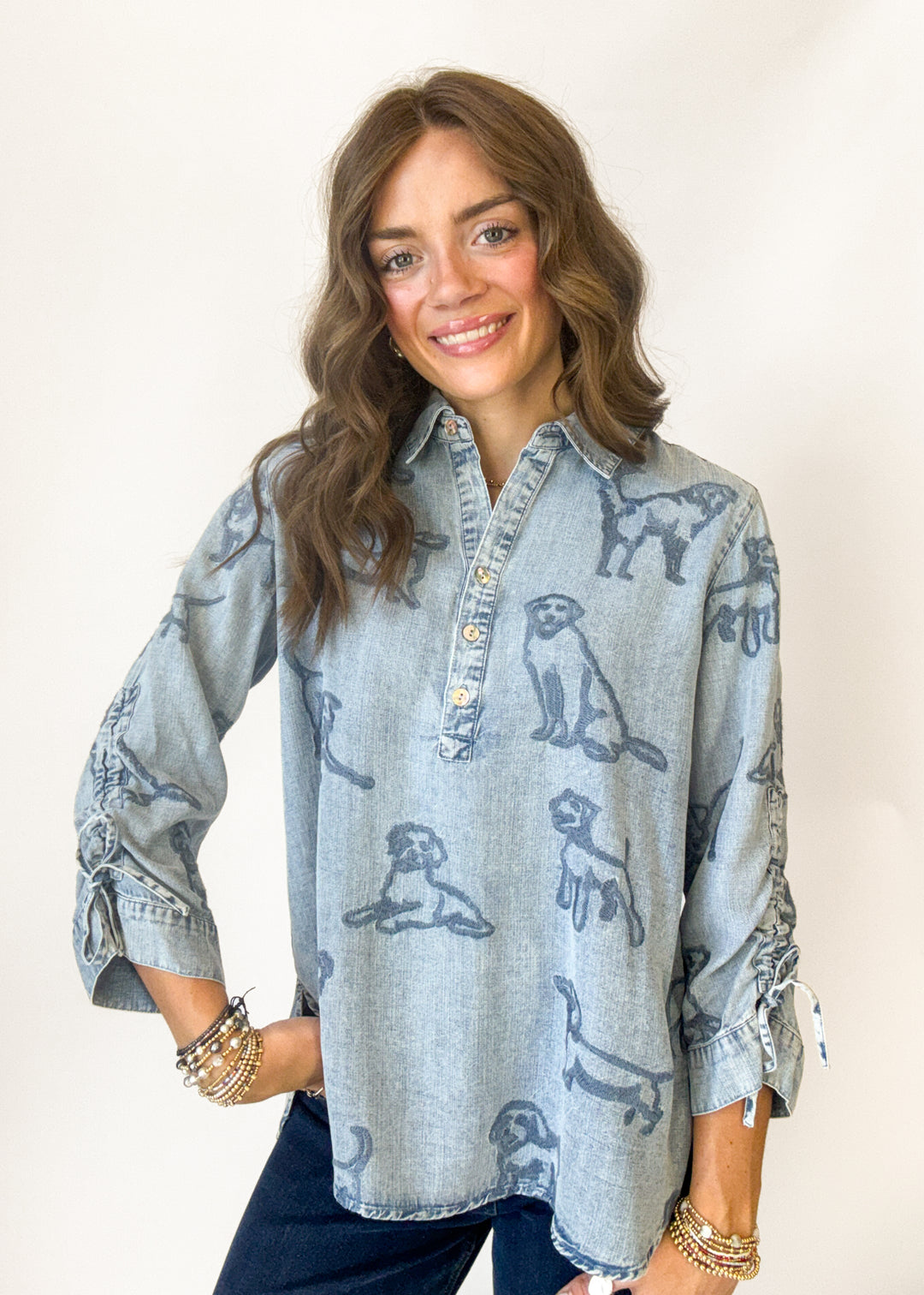 Woman wearing a denim top with puppy embroidery