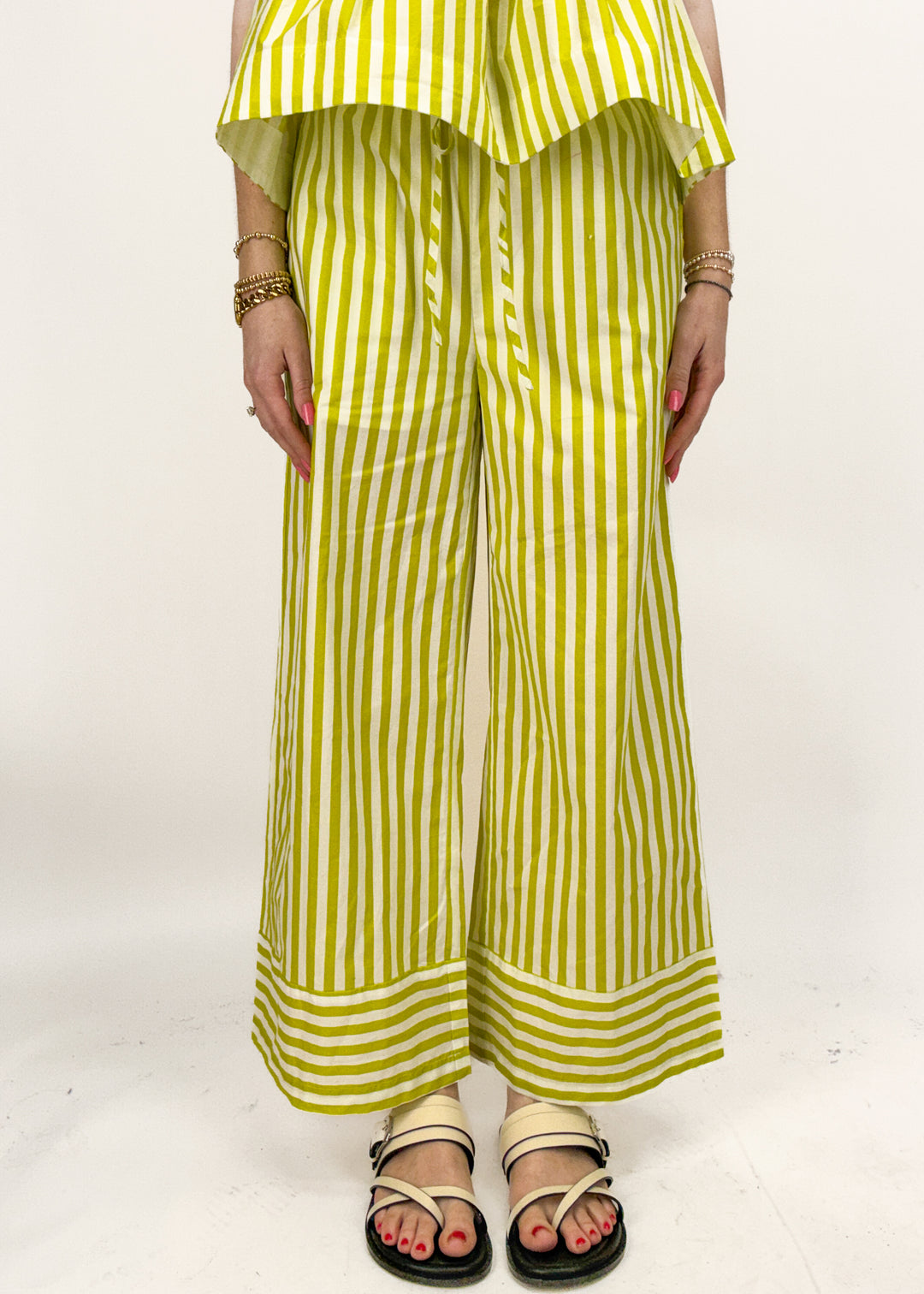 Person wearing a yellow and white striped outfit on a white background