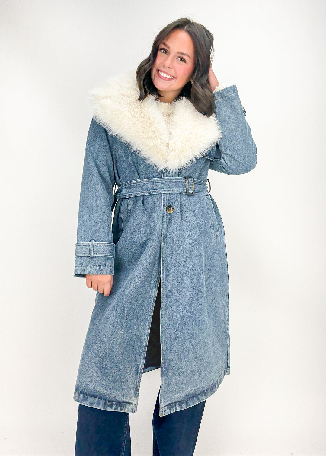 Woman wearing a denim coat with white fur trim 