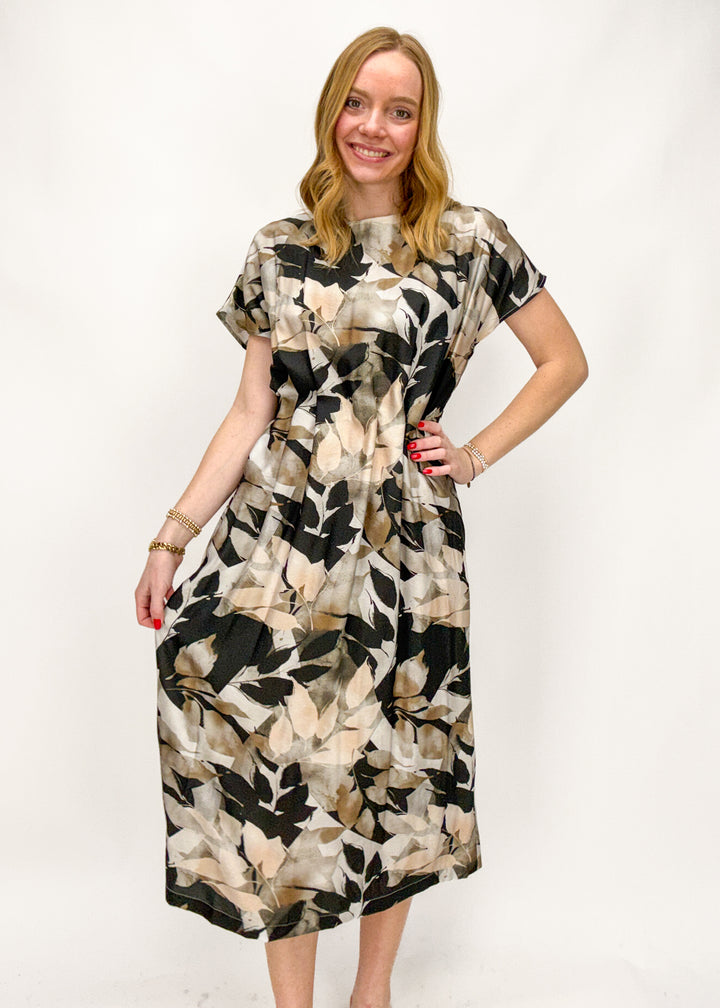 Woman wearing a patterned dress on a white background
