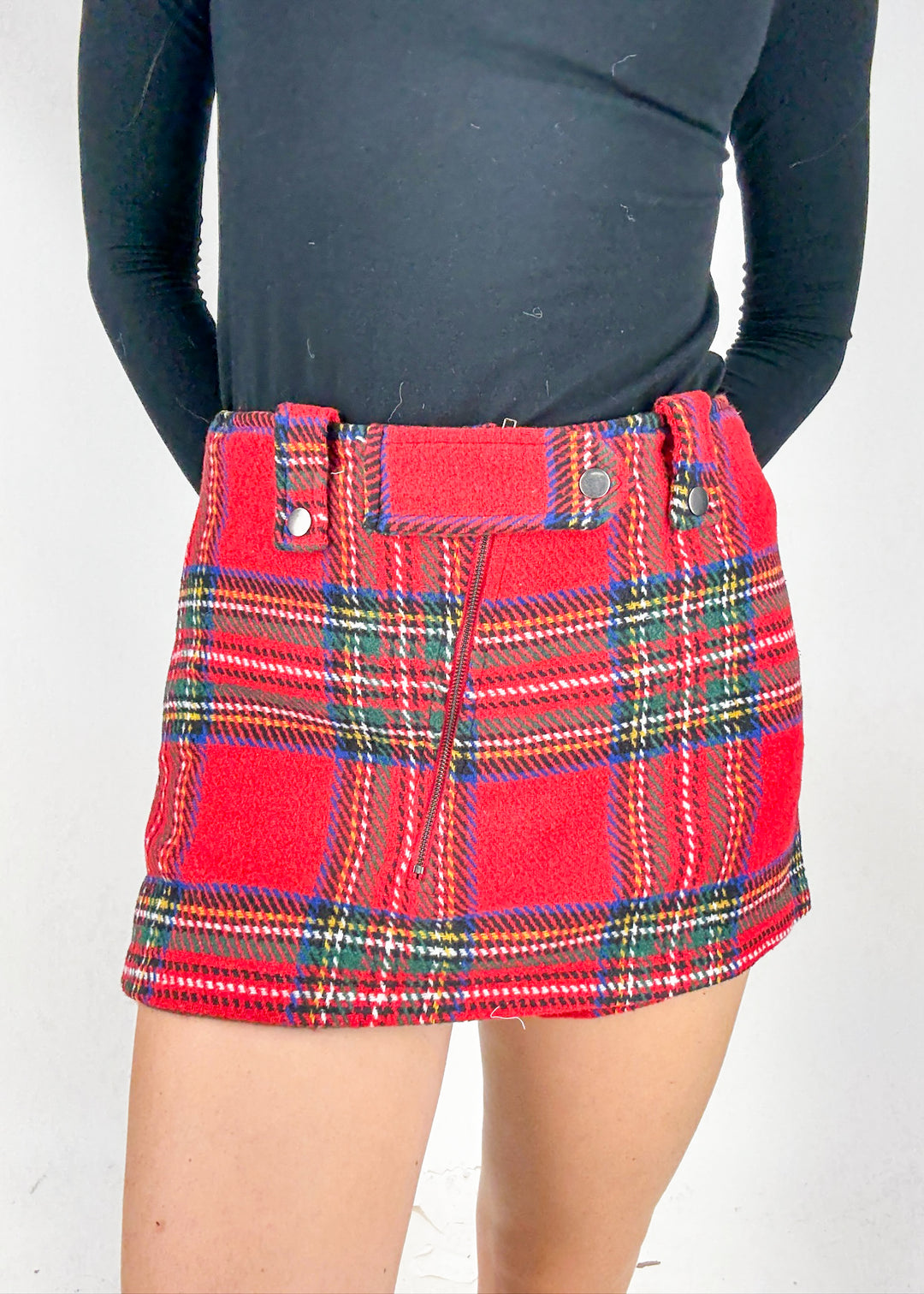 Red plaid skirt worn by a person 
