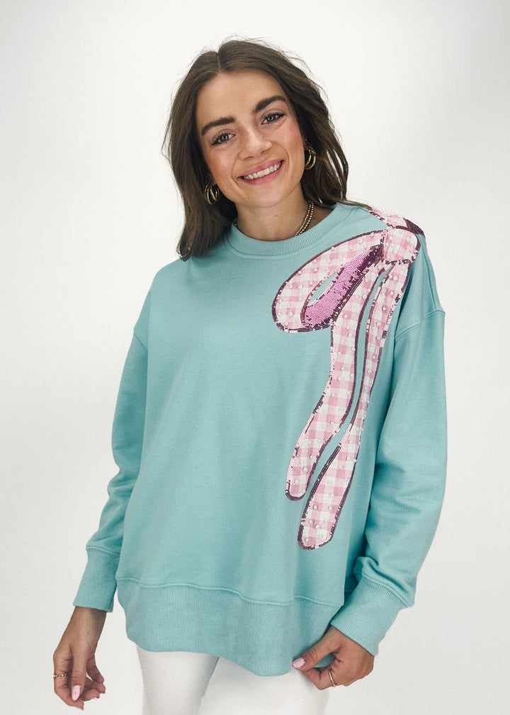 robins egg blue crew neck sweatshirt with pink gingham and sequin bow on shoulder